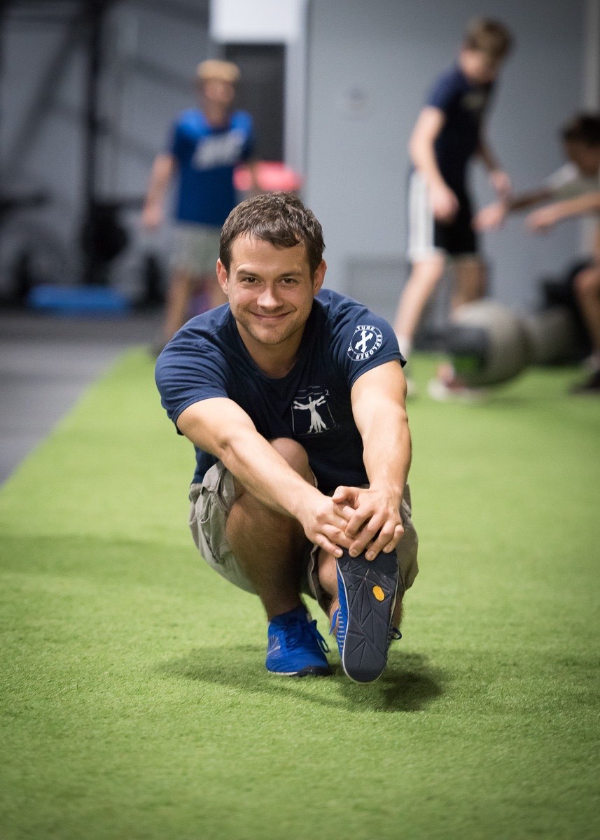 Client rebuilding strength and balance on turf after physical therapy