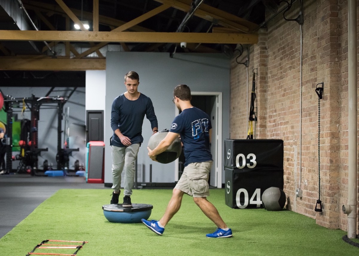 Adult client training balance and coordination with a Twice as Fit movement coach