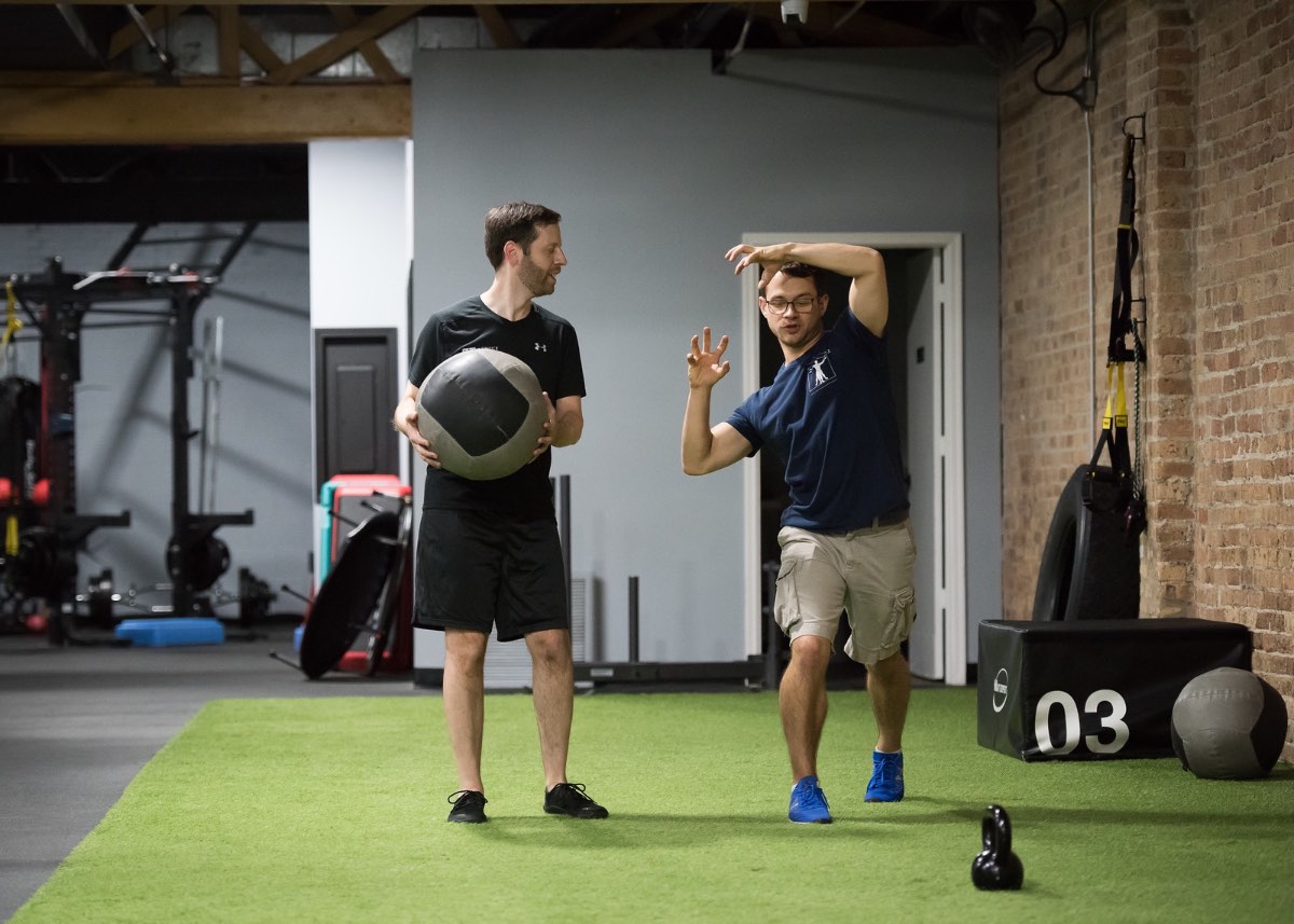 Strength and rotation training with a medicine ball during a one-to-one coaching session